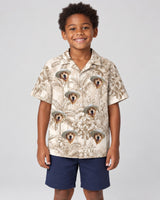 Beige Island Breeze Hawaiian shirt with printed faces, worn by a child
