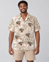 Beige Island Breeze Hawaiian shirt with printed faces, worn by a man