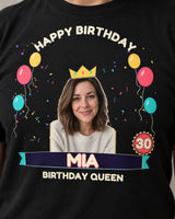 Close-up of the birthday print on a black shirt showing a crowned portrait, cream lettering and printed speckles inside the age 30 badge.