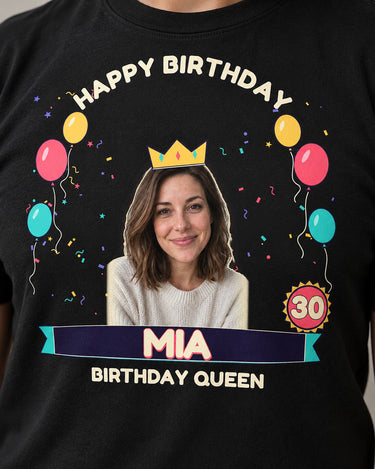 Close-up of the birthday print on a black shirt showing a crowned portrait, cream lettering and printed speckles inside the age 30 badge.