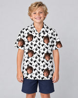 Black Cat Silhouette Halloween Hawaiian shirt with printed faces, worn by a child