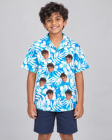Blue Hibiscus Breeze Hawaiian shirt with printed faces, worn by a child