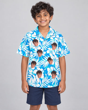 Blue Hibiscus Breeze Hawaiian shirt with printed faces, worn by a child