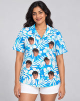 Blue Hibiscus Breeze Hawaiian shirt with printed faces, worn by a woman