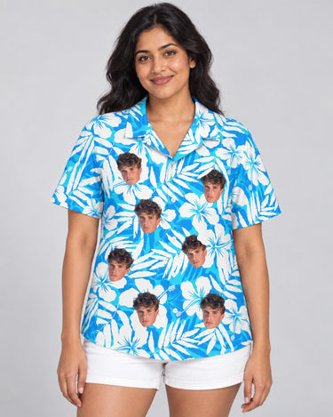 Blue Hibiscus Breeze Hawaiian shirt with printed faces, worn by a woman