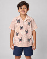 Blush Tropics Hawaiian shirt with printed faces, worn by a child