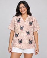 Blush Tropics Hawaiian shirt with printed faces, worn by a woman