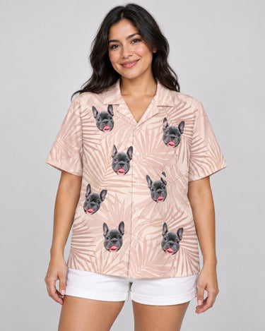 Blush Tropics Hawaiian shirt with printed faces, worn by a woman