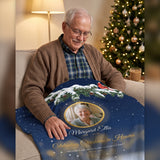 Widower looking at his late wife on a personalized Christmas memorial photo blanket with a red cardinal