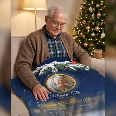 Widower looking at his late wife on a personalized Christmas memorial photo blanket with a red cardinal