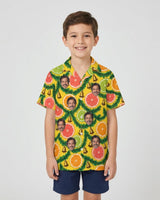 Citrus Garland Christmas Hawaiian Shirt with printed faces, worn by a child