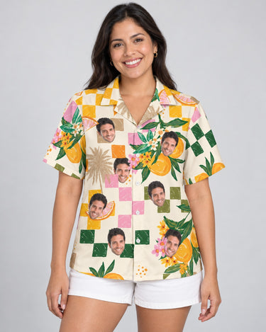 Citrus Splash Hawaiian shirt with printed faces, worn by a woman