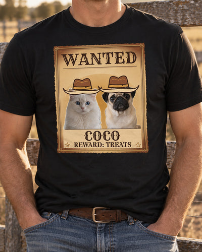 Black western pet photo tee on an adult beside a ranch fence, showing a cowboy-hatted pug and white cat on an aged Wanted poster with the name COCO.