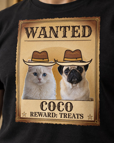 Close view of the Wanted print on a black western pet tee, with aged parchment, rope border, cowboy hats, the name COCO and the line REWARD: TREATS.