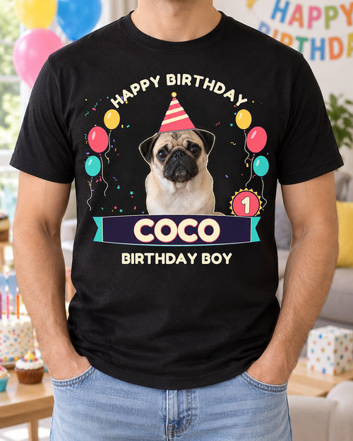 Black custom pet birthday tee with a pug in a striped party hat, rainbow balloons, age 1 badge, Coco ribbon and Birthday Boy lettering.