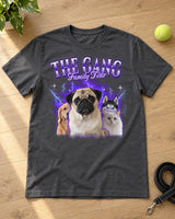 Charcoal big face pet bootleg t-shirt laid flat on a wooden floor with a dog leash and a tennis ball, the name The Gang in purple lettering with five pet faces