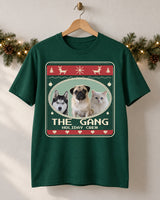 Forest green pet Christmas tee on a wooden hanger, showing three pets, The Gang lettering and red bands on an Evergreen sweater print