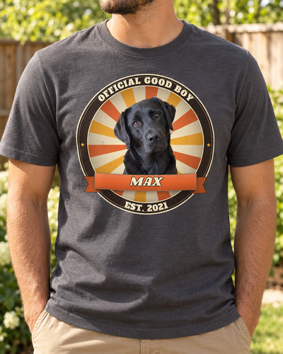 Man wearing a charcoal grey custom dog vintage badge t-shirt with a black Labrador in a retro sunburst circle and the name Max on a ribbon