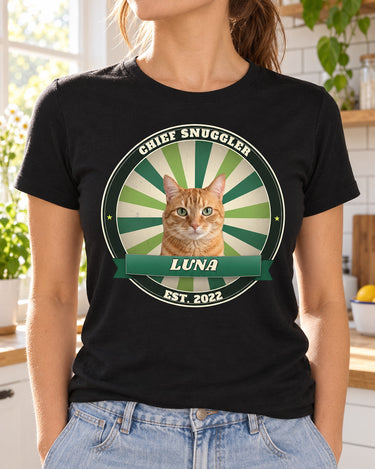 Woman wearing a black custom pet vintage badge t-shirt with an orange tabby cat in a green sunburst badge and the name Luna on a ribbon