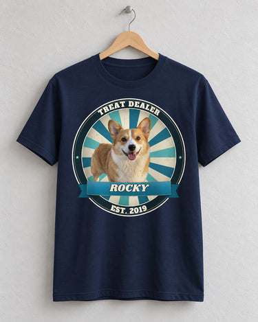 Navy custom pet vintage badge t-shirt on a wooden hanger with a corgi in a blue and teal sunburst badge and the name Rocky on a ribbon
