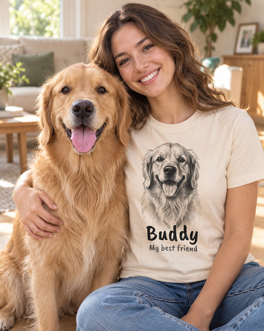 Smiling woman with her golden retriever wearing a natural cream pet sketch t-shirt that shows a pencil portrait of the same dog with the name Buddy