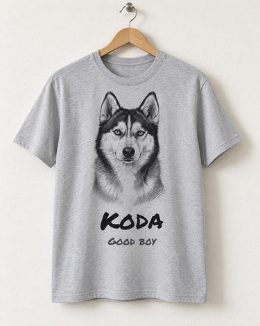 Light sport grey custom dog sketch t-shirt on a wooden hanger with a pencil portrait of a husky and the name Koda in bold marker lettering