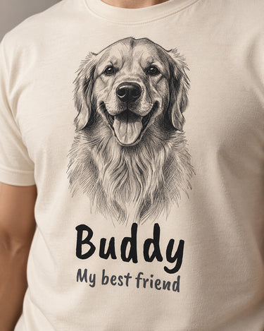 Close-up of the pencil sketch print on a natural cream t-shirt: a golden retriever drawn with fine graphite hatching