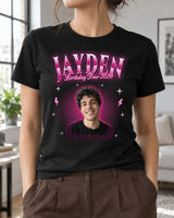 Woman wearing a black custom face bootleg rap tee with a young man's portrait, hot pink glow, chrome lettering Jayden and Birthday Tour 2026