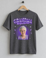 Dark heather custom face bootleg rap tee on a wooden hanger with a grandmother's portrait in a purple glow and the name Grandma