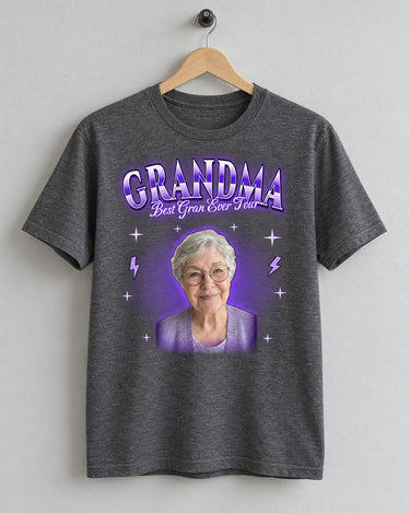 Dark heather custom face bootleg rap tee on a wooden hanger with a grandmother's portrait in a purple glow and the name Grandma