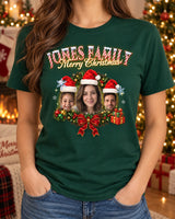 Woman wearing a forest green custom face Christmas t-shirt with three faces in Santa hats inside a holly wreath and the name Jones Family in candy-cane letters