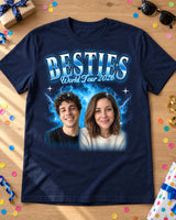 Navy custom face collage t-shirt laid flat on an oak table with birthday confetti, sunglasses and a gift, two faces in an ice blue glow and the name Besties