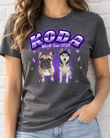 Woman wearing a dark heather grey pet bootleg t-shirt with the name Koda in purple lettering and a French bulldog and a husky