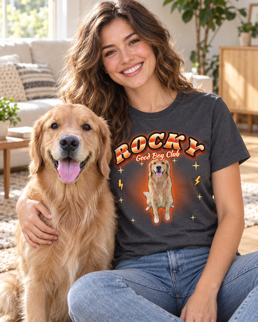Smiling woman with her golden retriever wearing a charcoal pet bootleg t-shirt that shows the same dog with the name Rocky in orange lettering