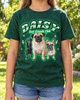 Child wearing a forest green kid-size pet bootleg t-shirt with the name Daisy in neon green lettering and a pug, a black Labrador and a French bulldog
