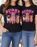 Two women wearing matching black pet bootleg t-shirts with the name Buddy in pink chrome lettering and a pug, a golden retriever and a tabby cat
