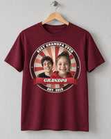 Maroon Dad Est. photo badge t-shirt on a wooden hanger with two kids' faces, cherry badge colors and the name Grandpa