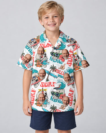 Day of the Dead Surf Skeleton Hawaiian shirt with printed faces, worn by a child