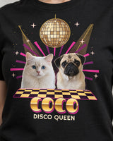 Close-up of the gold disco print on a black shirt, showing mirror tiles, pug and cat portraits, checkerboard squares and metallic-look Coco lettering.
