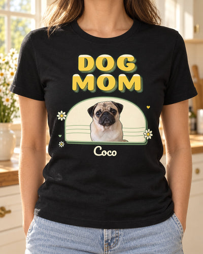 Black dog mom photo shirt in a sunny kitchen, with large retro DOG MOM letters, a pug inside a daisy arch and Coco in small script beneath the portrait.