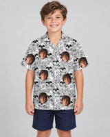 Edgy Skull Surf Hawaiian shirt with printed faces, worn by a child