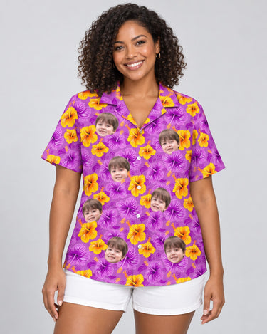 Enchanted Hibiscus Garden Hawaiian shirt with printed faces, worn by a woman