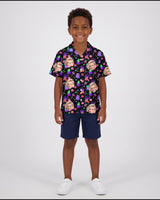 Floral Ghost Halloween Hawaiian shirt with printed faces, worn by a child
