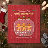 Gingerbread cookie jar blanket laid flat on a wooden floor with Christmas stocking and candles