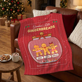 Personalized gingerbread blanket draped over a leather sofa next to hot cocoa and cookies