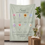 Personalized Christian blanket God Says You Are with name, watercolor flowers and Bible verse on a sage throw over the sofa