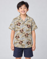 Golden Palm Leaves Hawaiian shirt with printed faces, worn by a child