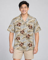 Golden Palm Leaves Hawaiian shirt with printed faces, worn by a man