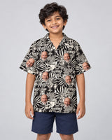 Gothic Palm Skull Surf Hawaiian shirt with printed faces, worn by a child