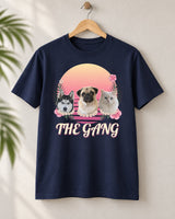 Navy Aloha pet photo tee on a wooden hanger, with three pets wearing flower leis against a Flamingo Pink sunset and The Gang in outlined script.